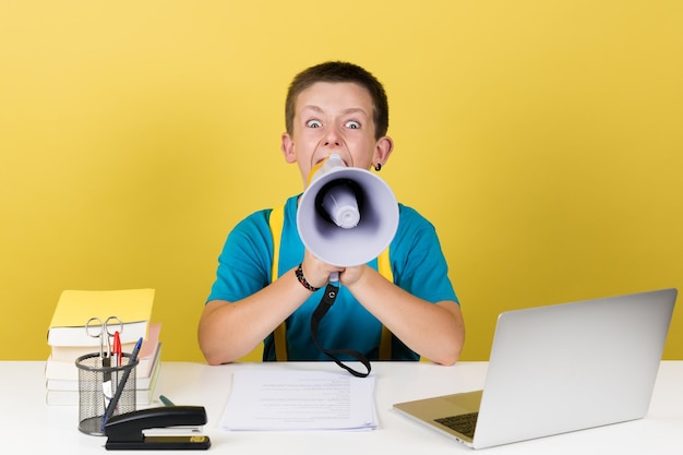 Angry boy shouting on loudspeaker and looking at camera