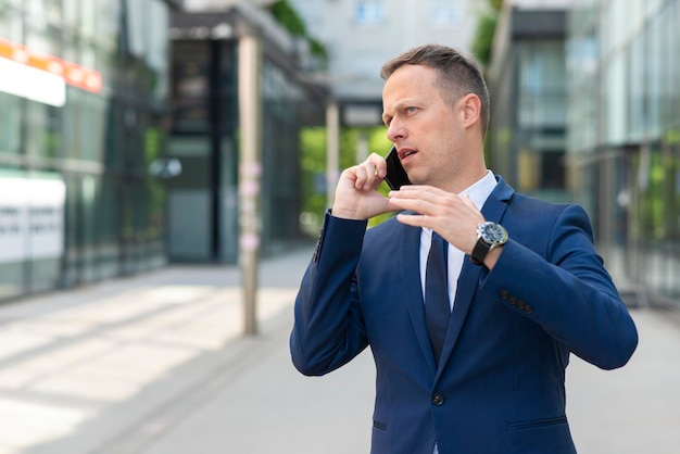 Angry business man talking on phone