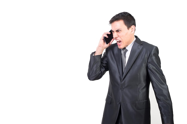 Angry businessman in suit having phone conversation