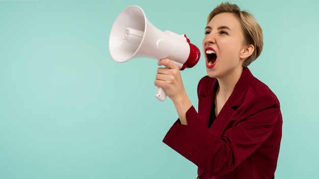 Angry businesswoman candidate with a megaphone on blue background - Image