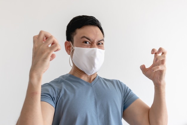 Angry and mad man in face mask on isolated white background.