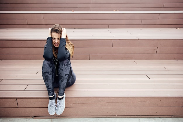 Angry sad young woman sitting outdoor