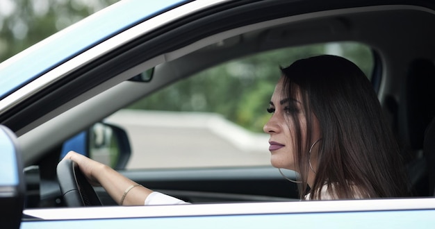 Angry woman explodes with negativity hitting wheel in car