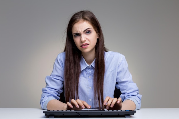 Angry woman using keyboard