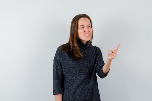 Angry young woman on white background