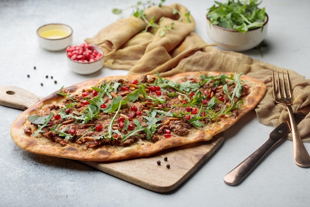 Angus Beef Pizza with pomegranate seeds served in dish isolated on table top view of arabian food