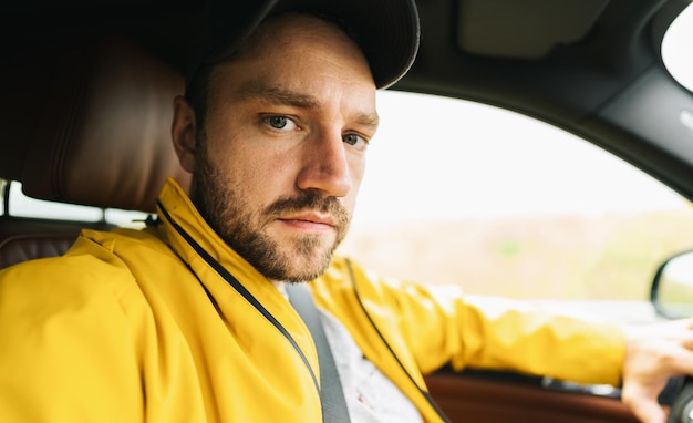 Angy young man solo traveler taking selfie in the car - Adventure wanderlust concept on the road