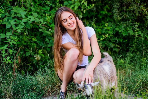 Animals are our pets woman vet feeding goat farm and farming Animals are our friends happy girl love goat village weekend summer day Love and protect animals contact zoo veterinarian goat