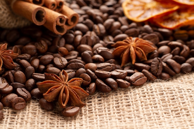 Anise or Badian lie on coffee beans along with natural flavored cinnamon sticks. Coffee concept. 