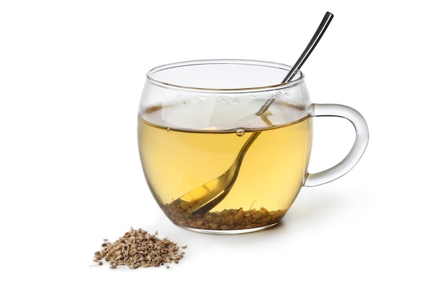 Photo anise tea in a glass cup on white background