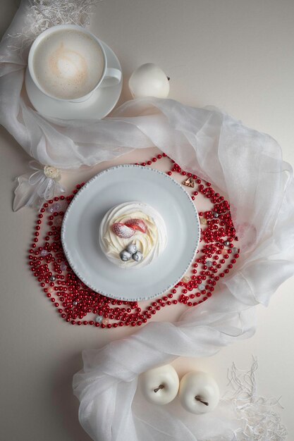 Anna Pavlova dessert with strawberry and blueberry on a white plate