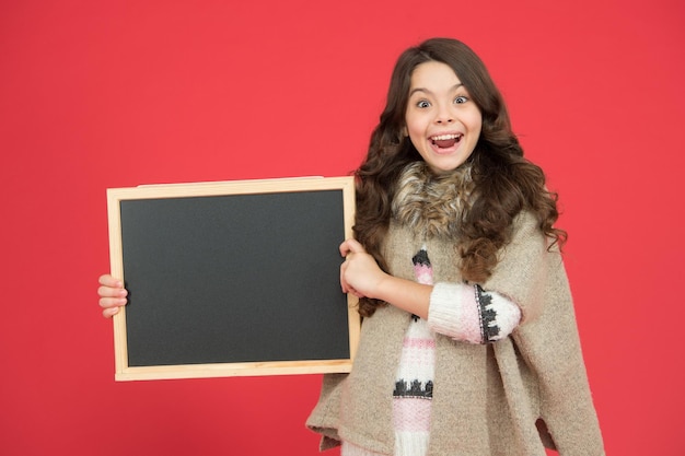 Announcement board Profitable deal Happy girl blank blackboard copy space Important information Winter activity advertisement Time for winter holiday Useful info Winter shopping sales