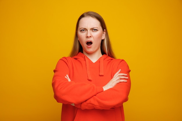 Annoyed young blonde woman standing with closed posture 