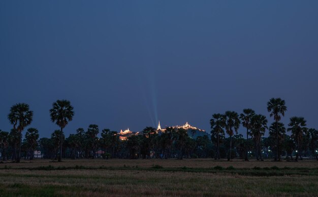 Annual festival of Khao Wang temple on hill in sugar plam plantation at dusk