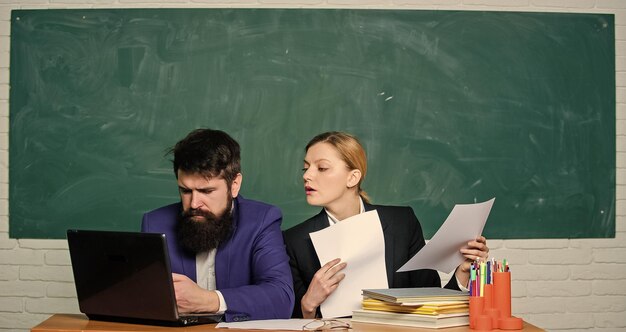 Annual report Teacher and supervisor working together in school classroom School educator with laptop and principal with documents Educational program School education Prepare for school lesson