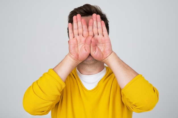 Anonymous caucasian man hiding his identity Studio shot