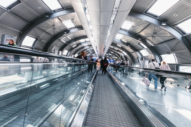 Anonymous commuter rushing in a futuristic tunnel