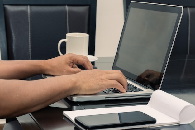 Anonymous Hands Of A Man Using His Laptop Computer