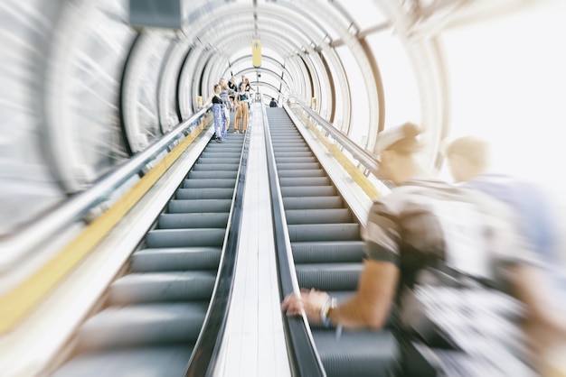 Anonymous people rushing on a escalator