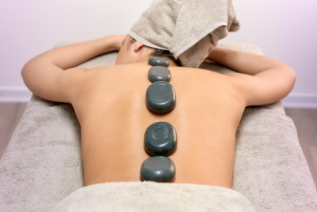 Anonymous woman during hot stone massage