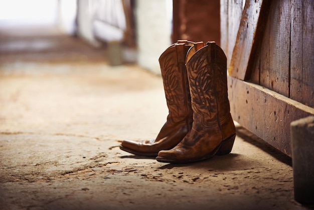 Another day done Shot of a pair of cowboy boots in a barn