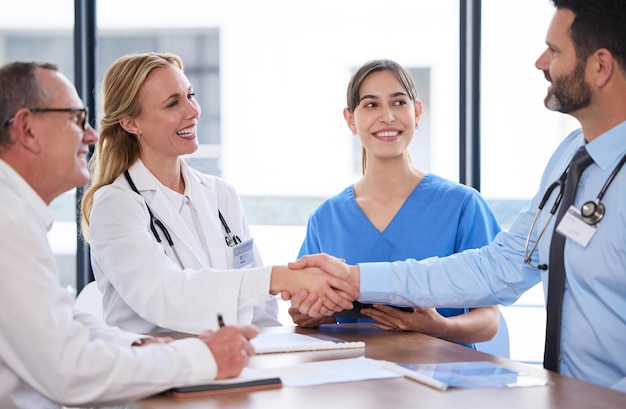 another member joining the team. Shot of two doctors shaking hands in a meeting at a hospital.