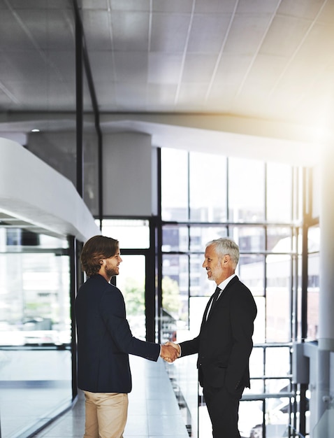 Another successful merger has been made Cropped shot of two businessmen shaking hands in an office