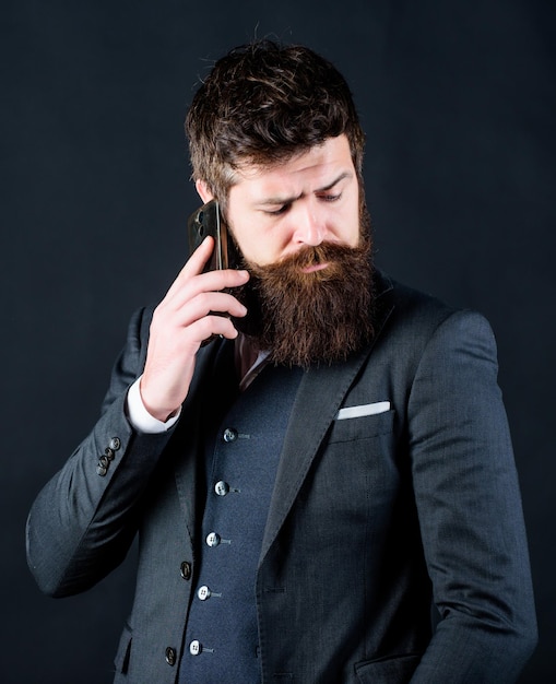 Another working day Bearded man with smartphone Male formal fashion brutal caucasian hipster with moustache businessman in suit business communication Mature hipster with beard speak on phone