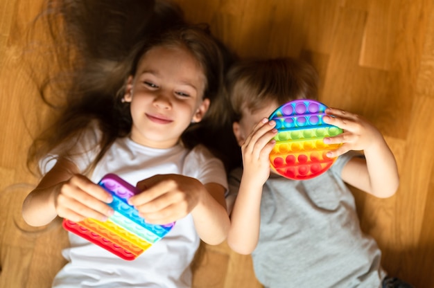 Anti stress sensory pop it toys in a children's hands. a little happy kids plays with a simple dimple toy at home. 