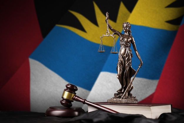 Antigua and Barbuda flag with statue of lady justice constitution and judge hammer on black drapery Concept of judgement and guilt