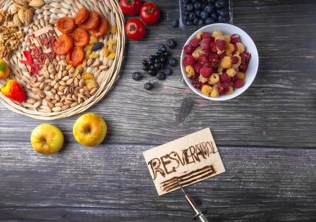 Antioxidants resveratrol food with text RESVERATROL on wooden surface