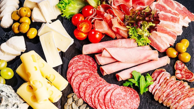 antipasti platter with assortment of italian salami cheese camembert and olives with tomatoes