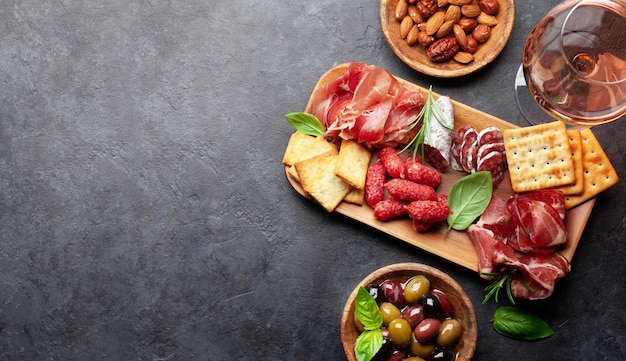 Antipasto board with prosciutto salami crackers cheese olives