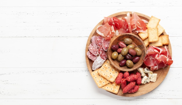 Antipasto board with prosciutto salami crackers cheese olives