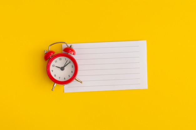 Photo antique alarm clock on a yellow background.