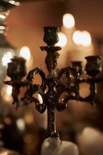 antique candlestick Retro candlestick on a wooden table on a black background