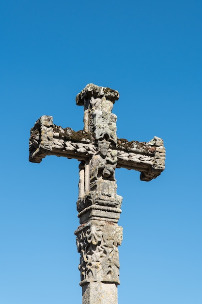 Antique carved stone cross with Virgin Mary holding Child Jesus in her arms. Copy space