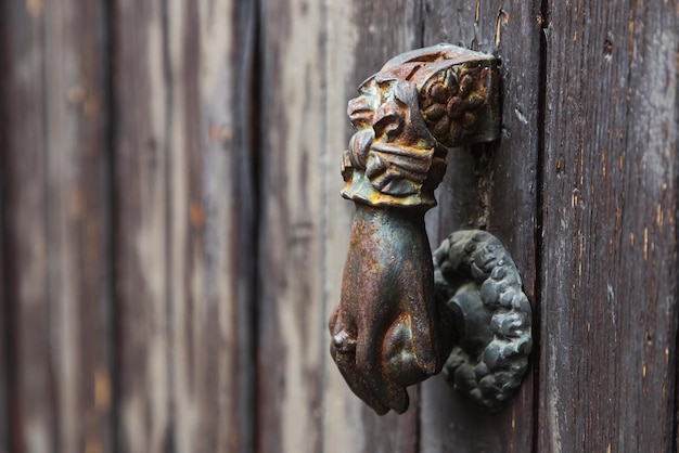 Antique door handle in the shape of a hand closeup