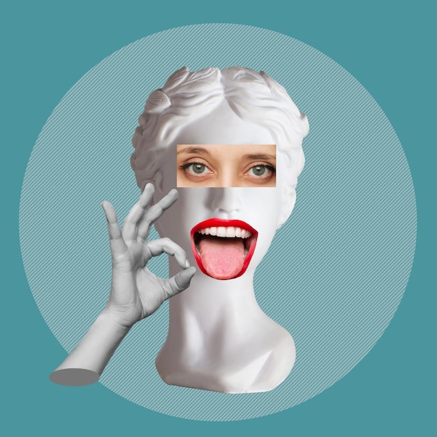 Antique female statue's head shows tongue and the ok gesture with hand on teal blue color background