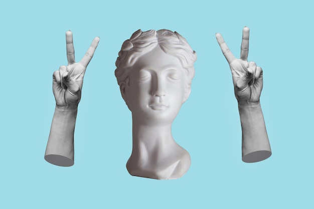 Antique female statue showing a peace gesture with hands isolated on a blue color background