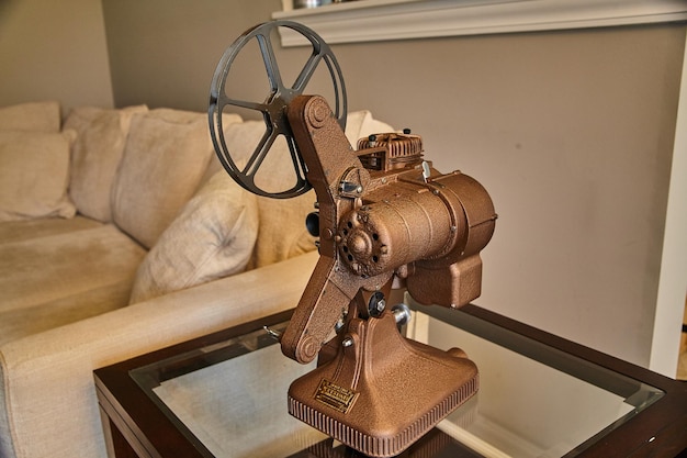 Antique Film Projector on Glass Table with Cozy Interior Background