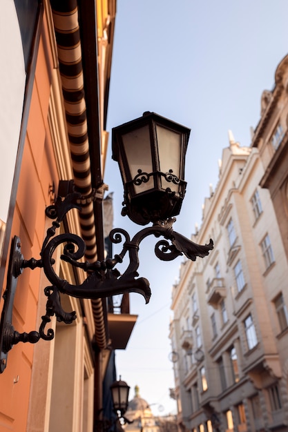 Antique forged lantern on the wall. Lviv, Ukraine