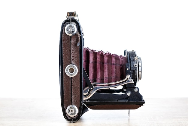 Antique old photo camera isolated on white