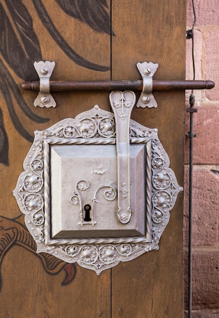 Antique silver door lock on timber