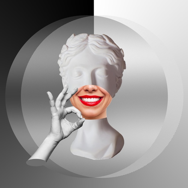 Antique smiling female statue's head with red lips shows the ok gesture with hand on black and white