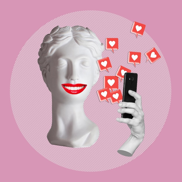 Antique smiling statue's head holding mobile phone with like symbols from social networks