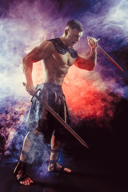 Antique warrior with sword against background with smoke