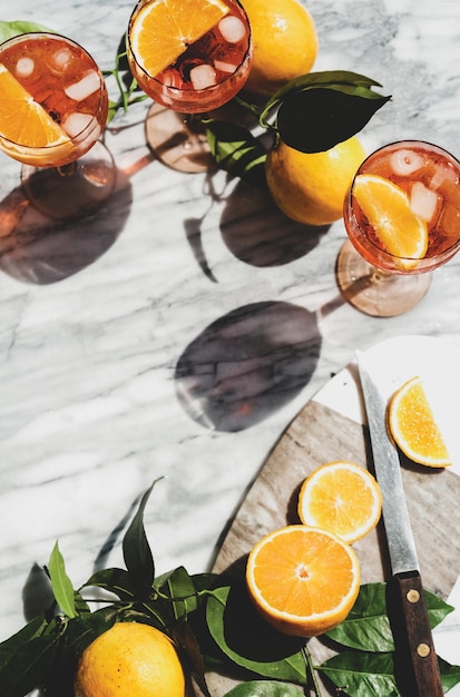 Aperol Spritz cocktail in glasses with oranges top view copy space