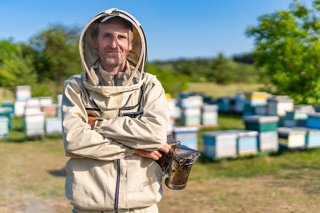 Apiarist in protective beekeeping suit Portrait of handsome beekeeper