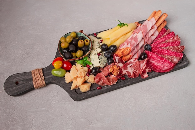 Appetizer assortment set sausage and cheese on a wooden board top view no people